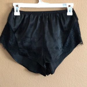 Black satin shorts with lace cutouts